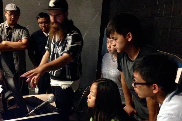 WFNU intern Jon Riddle training Center for Hmong Arts and Talent's Youth Leadership Group (YLG) on how to operate the station's equipment. YLG is currently in the process of producing their own show, Second Generation Radio, that focuses on issues that matter to Hmong youth.