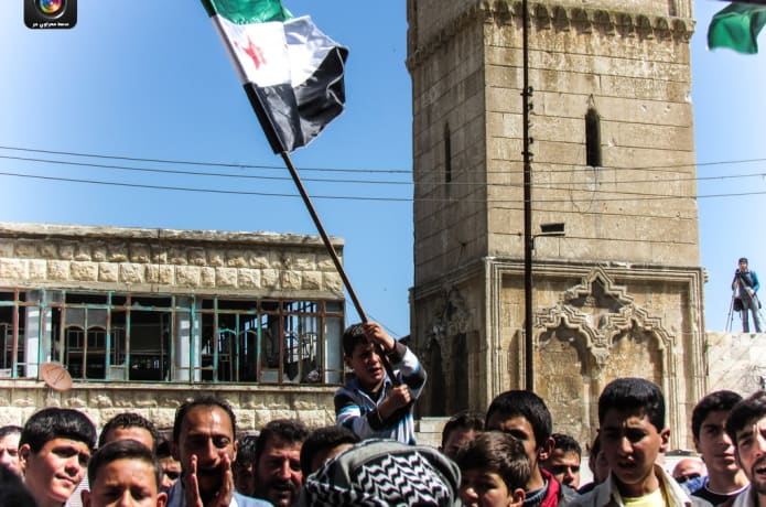 Demonstration in the town-square, infront of the Great Mosque, built in 1199. The mosque has been heavily damaged from regime bombings.

Photos: Massoud Lens/Marawi Free Lens